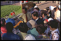 Asian tour group visiting Connie, a perennial protester outside the White House (Washington, D.C.). This photo was taken shortly after Bill Clinton closed Pennsylvania Avenue to traffic by commoners.