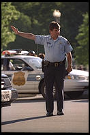 Traffic cop trying to untangle the perpetual traffic jam created in Washington, D.C. by Bill Clinton's closure of Pennsylvania Avenue to traffic by commoners.