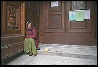 A gypsy begging on the steps of Florence's San Lorenzo