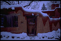 Adboe house and snow.  Santa Fe, New Mexico