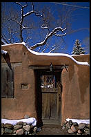 Adboe house and snow.  Santa Fe, New Mexico