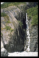 Water falling off the cliffs near the glaciers on the west coast of the South Island of New Zealand.