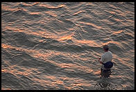 Fishing at sunset.  Looking towards Sanibel Island from Fort Meyers, Florida