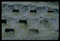 Cooling water flowing out of the Vermont Yankee nuclear power plant and back into the Connecticut River.  These concrete structures are designed to aerate the water and make it more useful to the life of the river.  Vernon, Vermont.